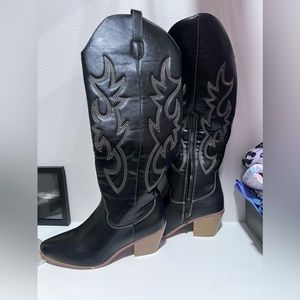 Knee high black boots with brown stitching